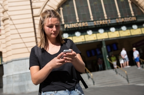 Young Woman Waiting Outside Flinders Street Staiton - Australian Stock Image