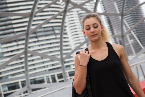 Young Woman Walking Across Webb Bridge Docklands - Australian Stock Image