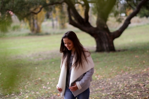 Young woman walking alone in the park - Australian Stock Image