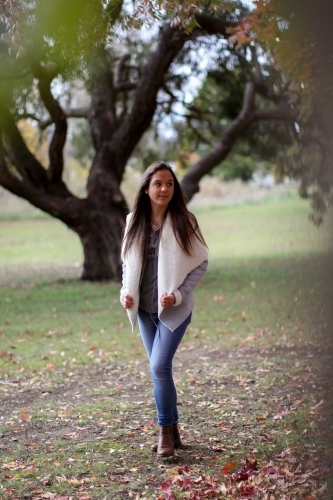 Young woman walking alone outdoors in nature - Australian Stock Image