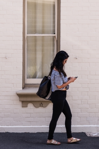 young woman walking in the city - Australian Stock Image