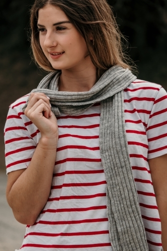 Young woman wearing a scarf.