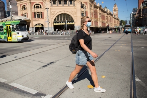 Young Woman Wearing Face Mask in Downtown Melbourne - Australian Stock Image