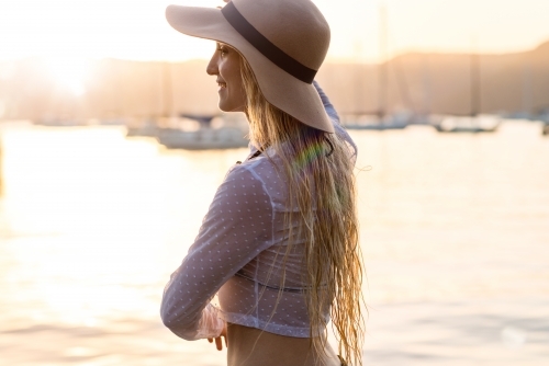 young woman wearing hat in afternoon light - Australian Stock Image