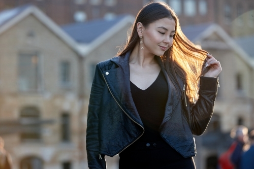 Young woman wearing leather jacket - Australian Stock Image