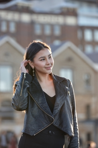 Young woman wearing leather jacket - Australian Stock Image