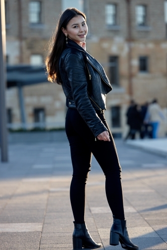 Young woman wearing leather jacket - Australian Stock Image