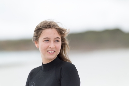 Young woman with wind in her hair on the beach