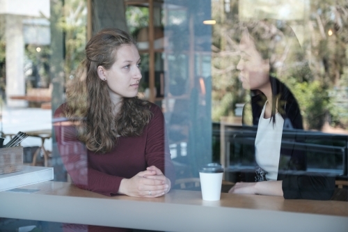 Young  women talking at coffee shop - Australian Stock Image
